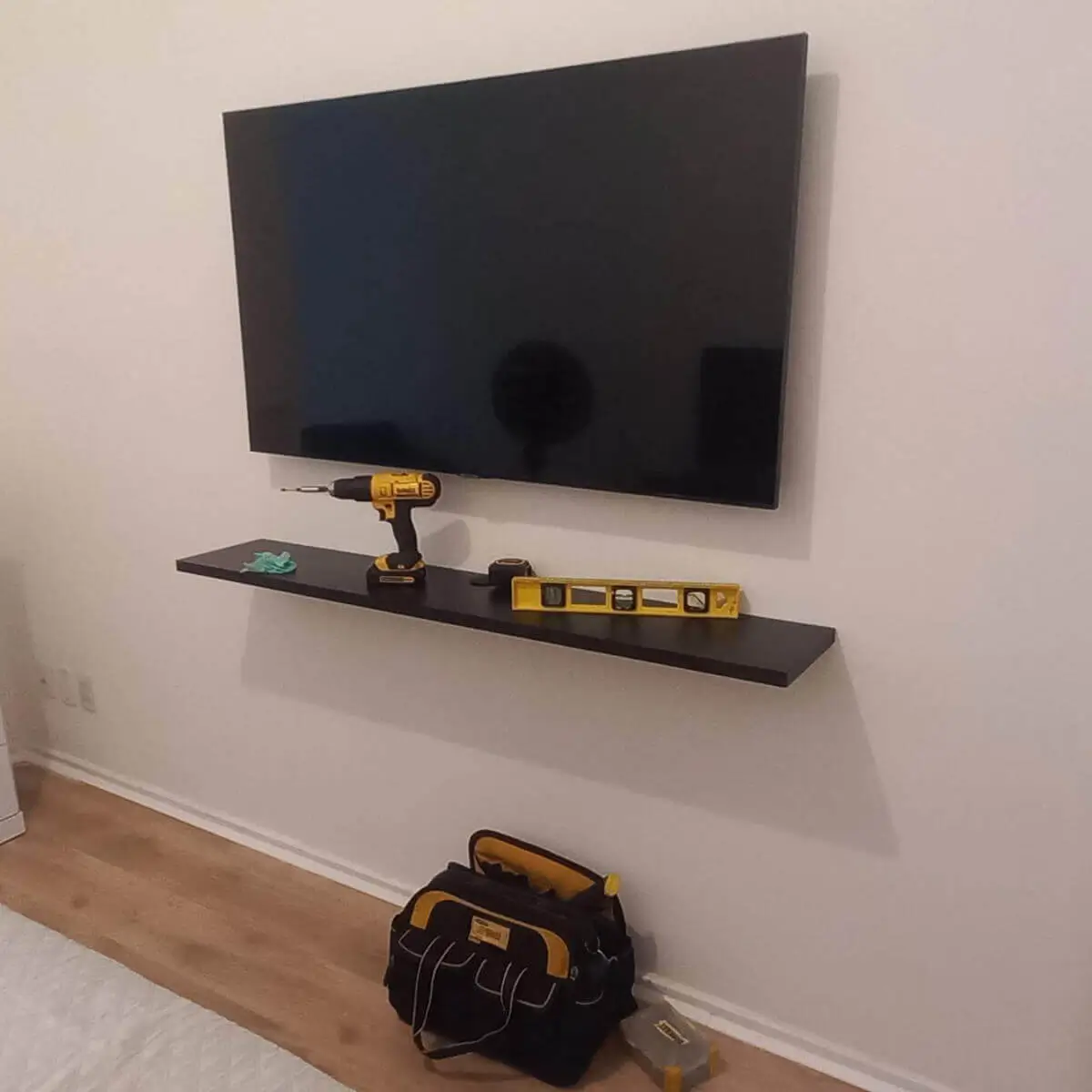 Instalador de Suporte de TV instalando suporte fixo com alinhamento preciso no Rio de Janeiro.